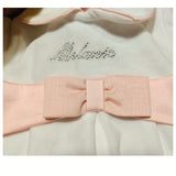 Tutina ciniglia luxury colorpanna con scritta con brillantini , inserti e fiocco brillantinato in satin